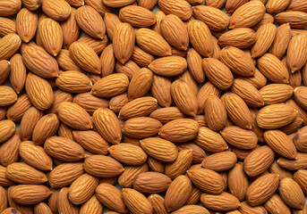 Fototapeta premium Full frame close-up of many raw almonds, both shelled and unshelled. Perfect for healthy eating and baking concepts.