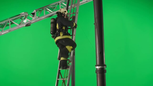 Professional Firefighter in Full Protective Gear Courageously Climbs a Ladder on a Green Screen
