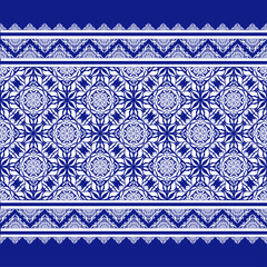 Beautiful seamless pattern of white flowers on a blue background.