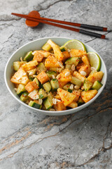 Rojak fruit vegetable salad with tofu cheese close-up in a bowl on the table. Vertical