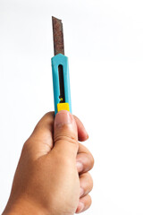 Hand holding old rusty box cutter for demolition or construction work needing replacement blade...