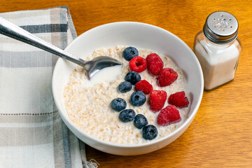 oatmeal top with blue berries and red raspberries