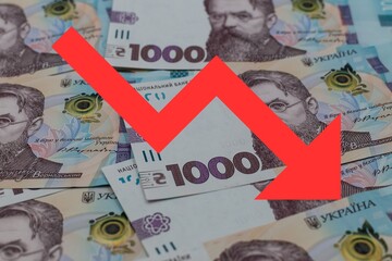 Red arrow pointing down against the Ukrainian hryvnia. Falling hryvnia exchange rate. Devaluation...