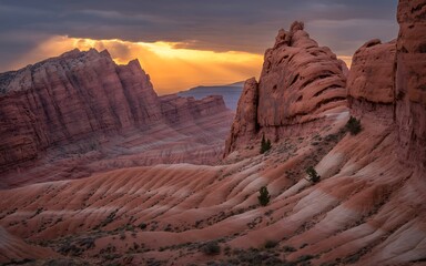 Naklejka premium Dramatic desert canyon landscape with sunbeams breaking through clouds over red rock formations at sunset