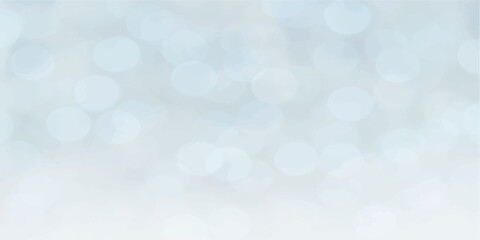 Abstract blue bokeh background with glowing lights and festive blurred texture