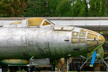 front section of an old military transport aircraft with a glazed cockpit and visible wear on the...