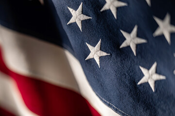 American flag close-up showcasing stars and stripes in rich colors. Texture with selective focus.