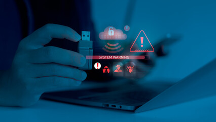 Close-up of a hand plugging a USB with digital system warning and malware alert icons. Concept of...