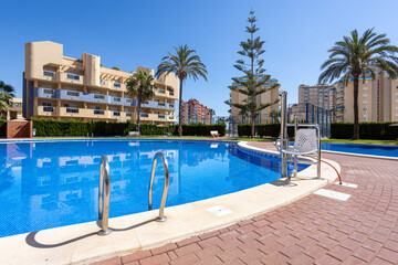 Swimming Pool and Apartment Complex under Clear Blue Sky