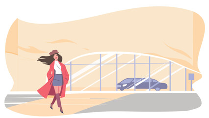 Woman in red coat and hat walking on a street with a car parked behind a glass wall structure