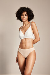 Young woman in stylish lingerie with curly hair.