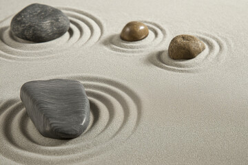Obraz premium Zen sand garden with minimal rock and raked patterns, overhead view, monochrome palette