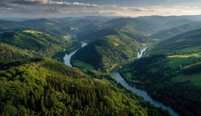 High-angle view of winding river through lush green mountains