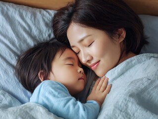 寄り添って眠る日本人の母親と子ども