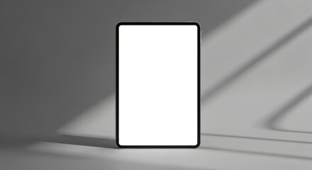 Modern Smartphone with Blank Screen Standing on Grey Surface in Natural Light