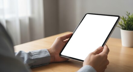 Person Holding Digital Tablet with Blank Screen in Modern Office Setting