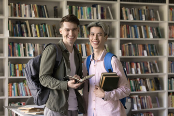 Ready for success. Portrait two happy teenage male students friends from different ethnic...