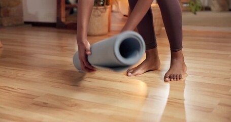 Person, hands and yoga mat with roll in home for workout completion, exercise or done activity. Active, feet or yogi folding equipment on wooden floor for stretch, zen or health and wellness in house