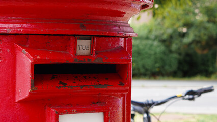 Close up of iconic red British mailbox used for traditional UK postal services