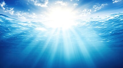 Beautiful Blue Ocean Background with Sunlight and Undersea Scene &ndash; Sunbeams Penetrating Turquoise Waters, Revealing Vibrant Marine Life Below