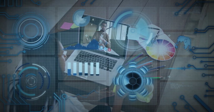 Designer working remotely on office desk, with laptop, color wheel, colored pencils, sticky notes - Powered by Adobe