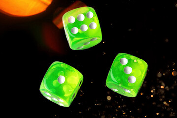 A random arrangement of green dice and a puzzle cup, captured after the dice have been cast.