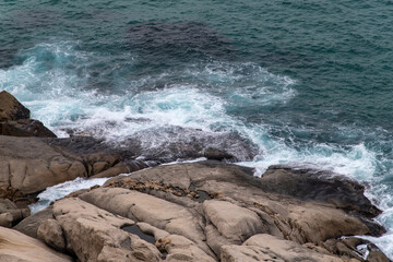 high angle view of the rocky beach with breaking waves