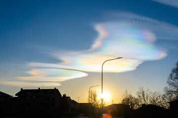 Rainbow clouds during sunset, also known as iridescent clouds, are a colorful optical phenomenon...