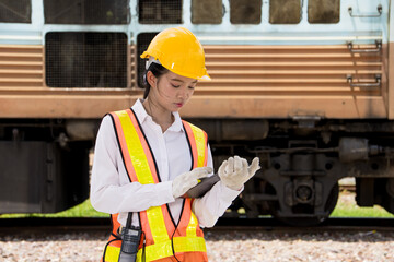 Asian young teen engineer worker work in Train station, Locomotive service station
