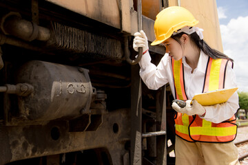 Asian young teen engineer worker work in Train station, Old locomotive service maintenance