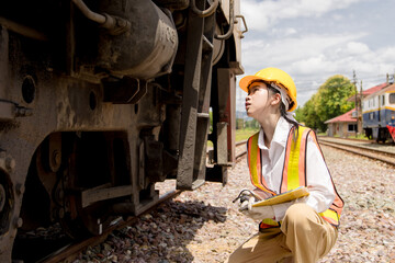 Asian young teen engineer worker work in Train station, Old locomotive service maintenance