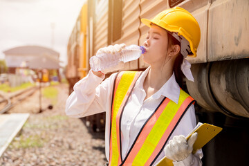 Young lady engineer worker drinking water refresh when working outdoor hot sunny day in summer