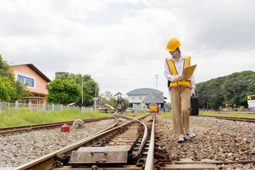 Asian young teen train engineer work check inspect service maintenance old locomotive railway track