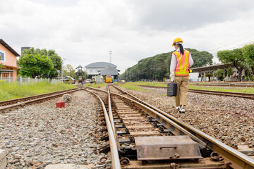 Asian young teen train engineer work check inspect service maintenance old locomotive railway track