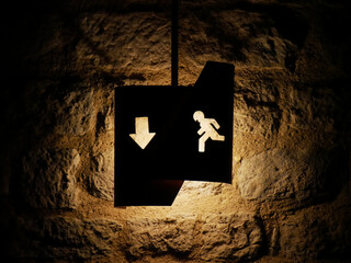 illuminated exit sign in a dark room of a cave or cellar