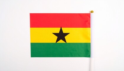 "Ghanaian national flag with three horizontal stripes—red, yellow, and green—with a central black five-pointed star in the yellow band, fluttering in open air, symbolizing freedom, unity, and African