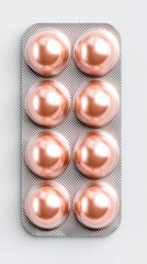 Round Tablets in Pharmaceutical Blister Pack Close-up of a blister pack containing shiny capsules for wellness and health.