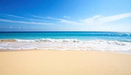 Fototapeta premium Sandy beach meets clear turquoise water under a bright blue sky