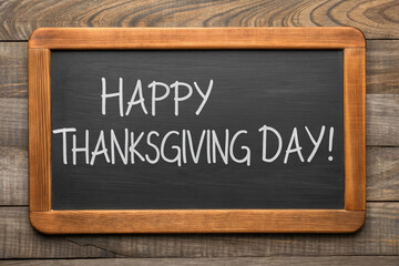 Obraz premium A Rustic Blackboard Displaying Warm Autumnal Greetings for the Holiday Season with a Wooden Frame on a Weathered Wooden Surface Backdrop