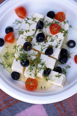 Feta cheese with olives, tomatoes and microgreens.