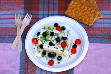 Feta cheese with olives, tomatoes and microgreens.