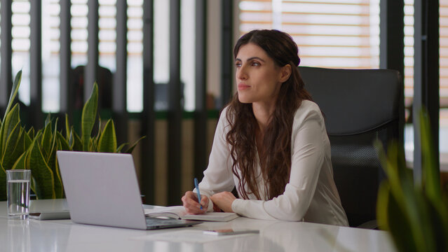 Caucasian thoughtful girl female businesswoman dreaming thinking business woman creative worker write in notebook writing notes planning tasks think consider ponder ideas smile study work in office