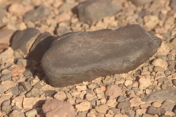 A close up of a black stone on the ground
