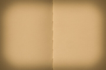 blank backdrop: two pages of opened aged notepad with shadowed edges