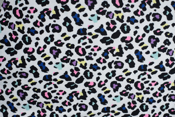Colorful leopard print with vibrant abstract spots on a white background fabric