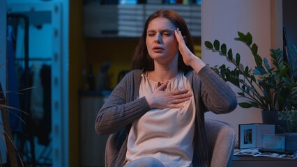 Fototapeta premium Caucasian woman suffer headache heart attack pain in chest sick ill unwell girl female at night evening home feel stress health problem ache heartache hurt in breast symptom cardiac pressure medicine