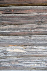 Close-up of old weathered wooden wall with cracks, decay, knots, and insect damage. Rustic texture, aged timber, natural erosion &mdash; ideal for backgrounds or textures