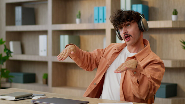 Office dancer Caucasian happy man business guy crazy funny businessman manager dancing listen music in headphones fooling joyful male freelancer dance fun at workplace move relax work break singing - Powered by Adobe