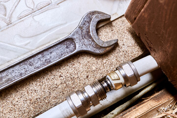 Compression fitting insert is positioned in front of multilayer pipe opening, once inserted, compression nut will tighten clamping ring.