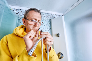 Replacing sealing ring on braided shower hose, plumber inserts new gasket into connector while...